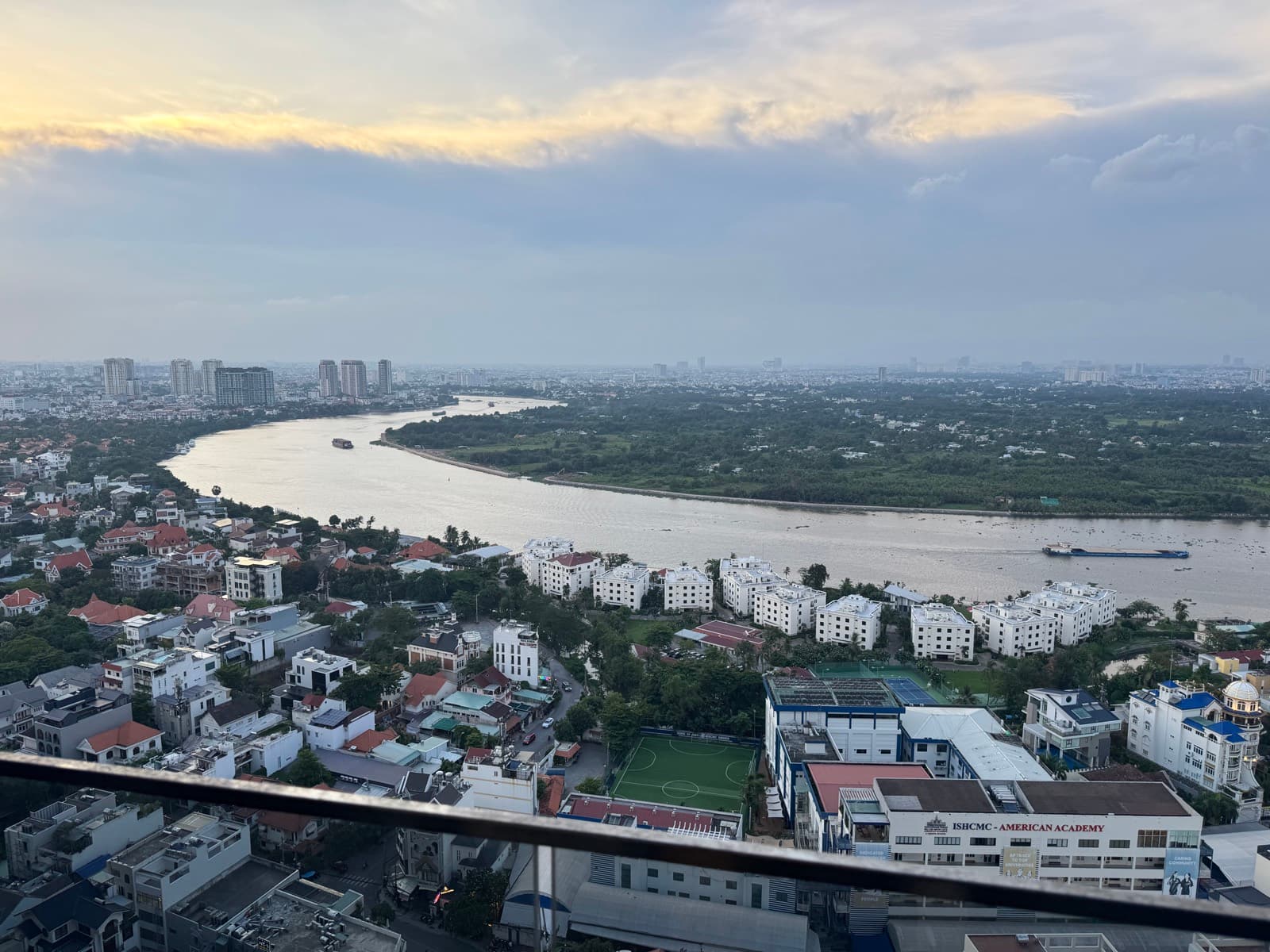 The Saigon river bending gold past Thao Dien at golden hour